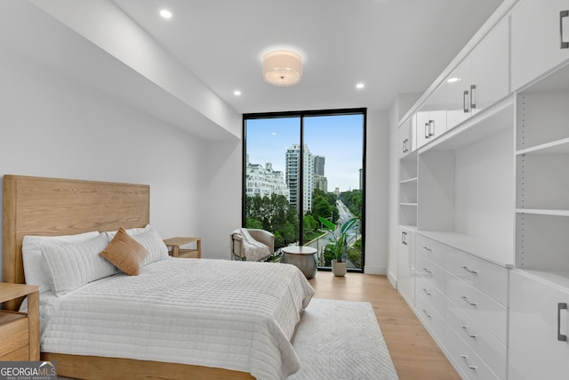 2425 Peachtree Rd NE Unit 902, Atlanta, GA 30305 - bedroom with floor to ceiling windows, light wood-style flooring, a view of city, and recessed lighting