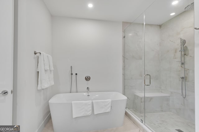 2425 Peachtree Rd NE Unit 902, Atlanta, GA 30305 - bathroom featuring a freestanding tub, a stall shower, and recessed lighting