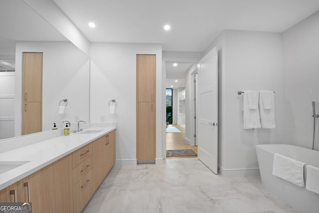 2425 Peachtree Rd NE Unit 902, Atlanta, GA 30305 - bathroom featuring a soaking tub, double vanity, marble finish flooring, and recessed lighting