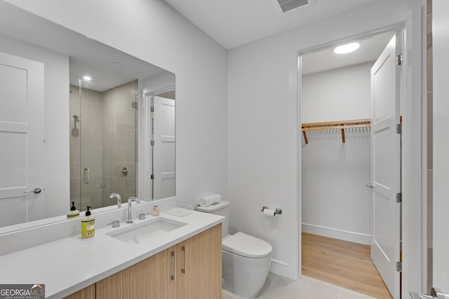 2425 Peachtree Rd NE Unit 902, Atlanta, GA 30305 - full bathroom with a stall shower, vanity, a walk in closet, and tile patterned flooring