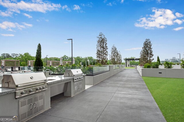 2425 Peachtree Rd NE Unit 902, Atlanta, GA 30305 - view of patio / terrace with an outdoor kitchen and a sink