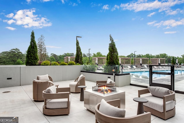2425 Peachtree Rd NE Unit 902, Atlanta, GA 30305 - view of patio / terrace featuring a fire pit and a community pool