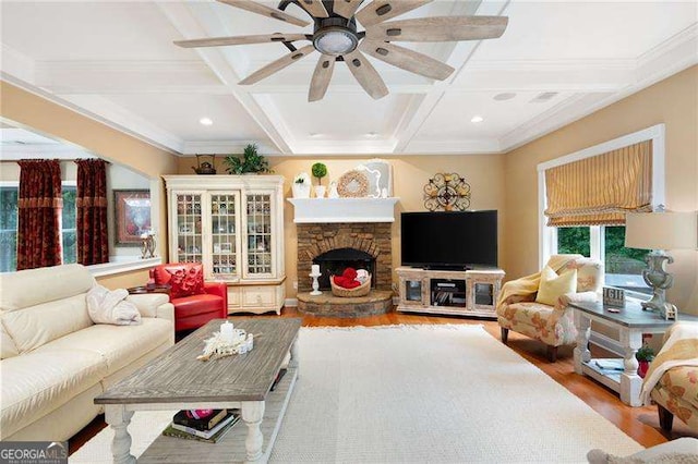 7131 Ridge Rd, Hiram, GA 30141 - living area featuring wood finished floors, coffered ceiling, beamed ceiling, a stone fireplace, and a ceiling fan