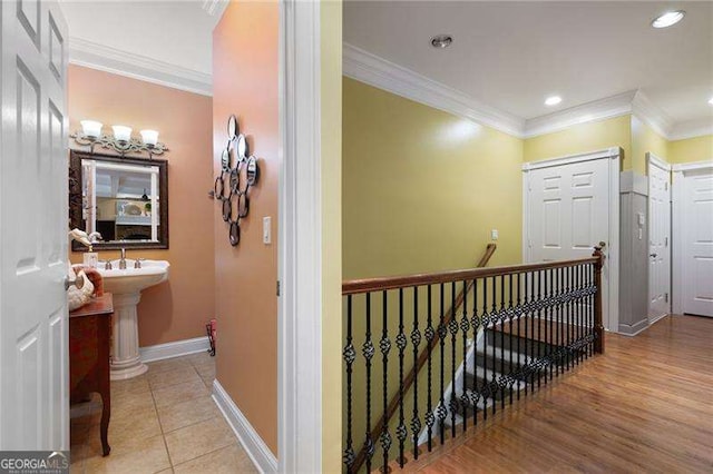 7131 Ridge Rd, Hiram, GA 30141 - corridor with an upstairs landing, crown molding, recessed lighting, and light tile patterned floors