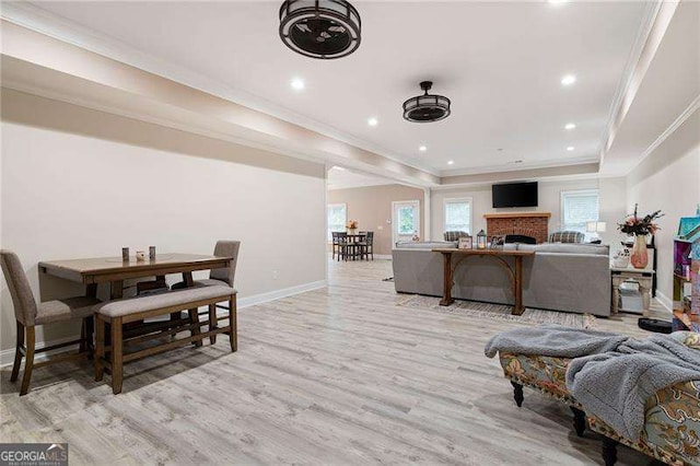 7131 Ridge Rd, Hiram, GA 30141 - living room with ornamental molding, a raised ceiling, light wood-style flooring, recessed lighting, and a fireplace