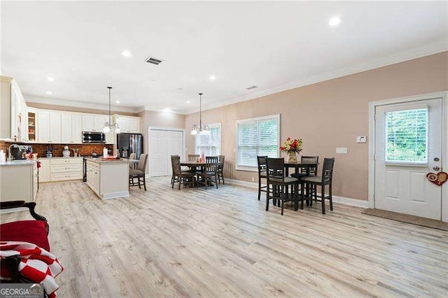 7131 Ridge Rd, Hiram, GA 30141 - dining space with plenty of natural light, light wood-style flooring, recessed lighting, ornamental molding, and baseboards