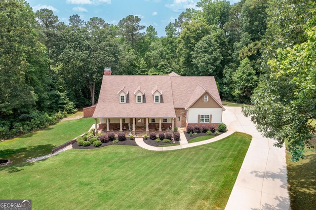 7131 Ridge Rd, Hiram, GA 30141 - new england style home with covered porch, concrete driveway, a front yard, and a chimney