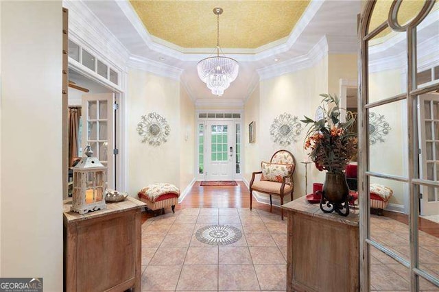 7131 Ridge Rd, Hiram, GA 30141 - entryway featuring ornamental molding, light tile patterned floors, a raised ceiling, and a chandelier