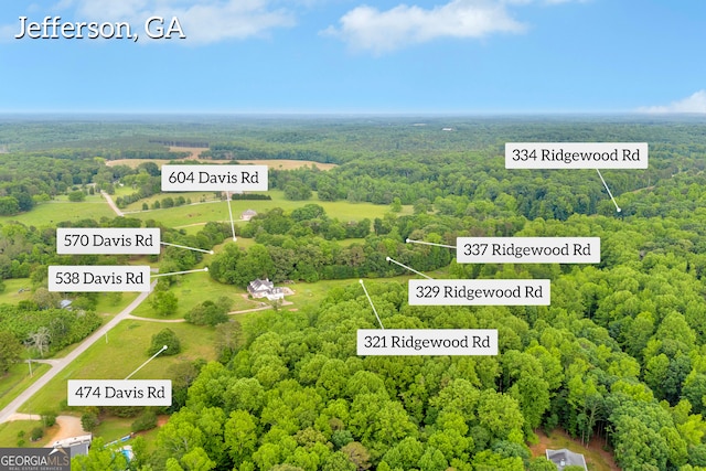 570 Davis Rd, Jefferson, GA 30549 - aerial view of property and surrounding area featuring a heavily wooded area and property parcel outlined