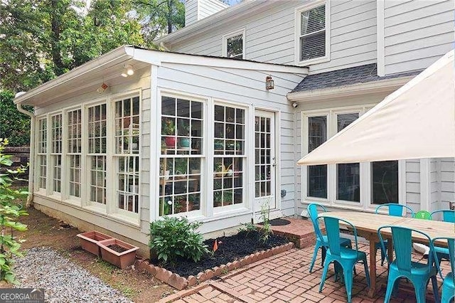 4213 Schooner Ct NE, Roswell, GA 30075 - view of side of property with outdoor dining area, a chimney, and a patio