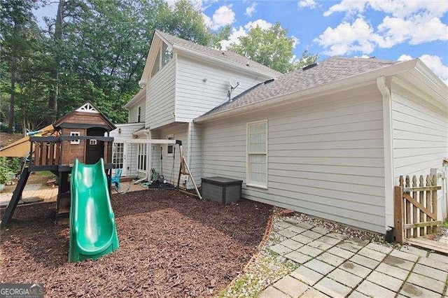 4213 Schooner Ct NE, Roswell, GA 30075 - rear view of property featuring a playground and a shingled roof