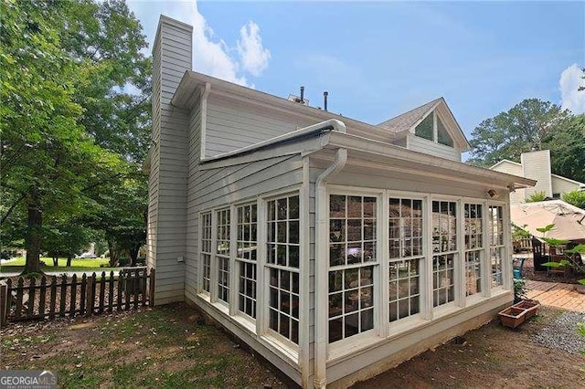 4213 Schooner Ct NE, Roswell, GA 30075 - view of side of home with a chimney and a sunroom