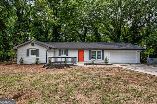 5640 Redan Cir, Stone Mountain, GA 30088 - single story home featuring an attached garage, concrete driveway, a porch, brick siding, and a front yard