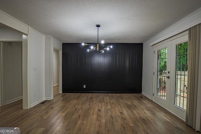 5640 Redan Cir, Stone Mountain, GA 30088 - unfurnished dining area with wood finished floors, a textured ceiling, a chandelier, baseboards, and french doors