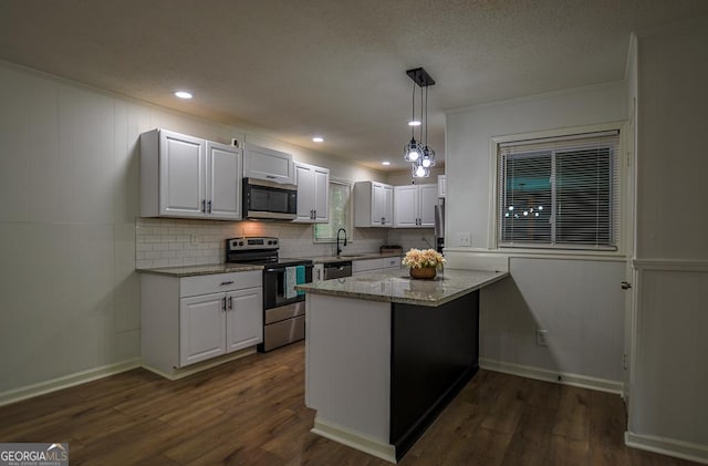 5640 Redan Cir, Stone Mountain, GA 30088 - kitchen with stainless steel appliances, decorative backsplash, a sink, white cabinetry, and light stone counters