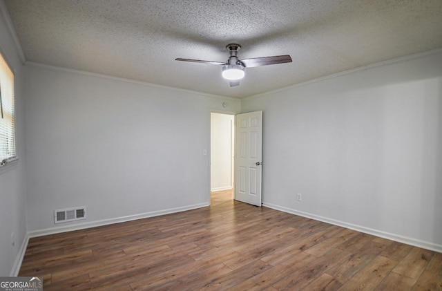 5640 Redan Cir, Stone Mountain, GA 30088 - empty room with hardwood / wood-style floors, ceiling fan, a textured ceiling, baseboards, and ornamental molding