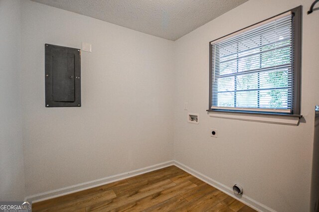 5640 Redan Cir, Stone Mountain, GA 30088 - empty room featuring electric panel, wood finished floors, baseboards, and a textured ceiling