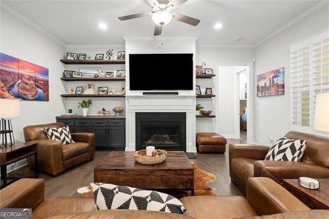 124 Calder Dr, Alpharetta, GA 30009 - living area featuring a ceiling fan, wood finished floors, ornamental molding, and a glass covered fireplace