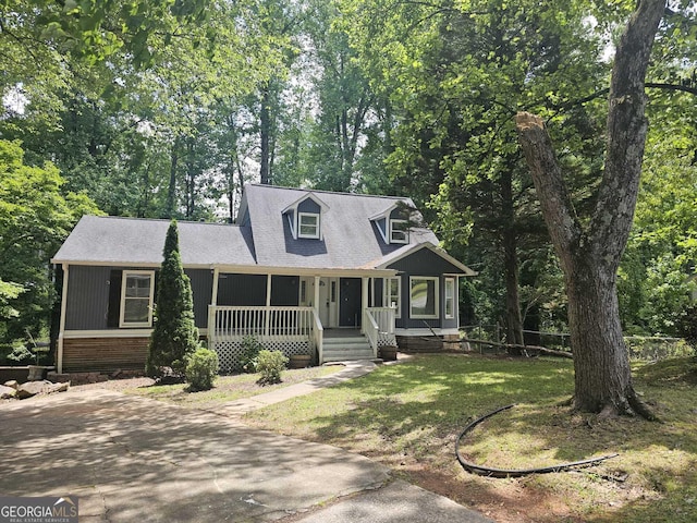 686 Favorwood Dr SW, Marietta, GA 30060 - new england style home featuring covered porch, a front lawn, and roof with shingles