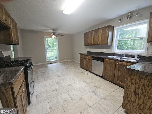 686 Favorwood Dr SW, Marietta, GA 30060 - kitchen with dishwasher, a sink, range with gas cooktop, ceiling fan, and baseboards