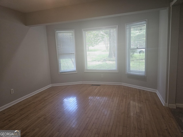 686 Favorwood Dr SW, Marietta, GA 30060 - spare room featuring dark wood-style floors, healthy amount of natural light, and baseboards