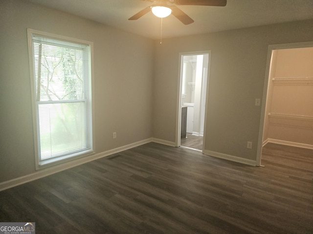 686 Favorwood Dr SW, Marietta, GA 30060 - unfurnished bedroom with a spacious closet, dark wood-style flooring, baseboards, a closet, and ensuite bath