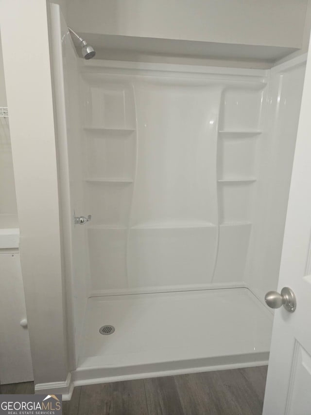 686 Favorwood Dr SW, Marietta, GA 30060 - bathroom with a stall shower and wood finished floors