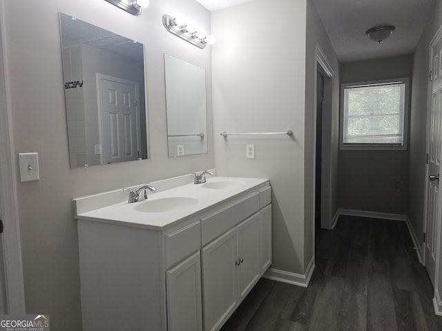 686 Favorwood Dr SW, Marietta, GA 30060 - full bathroom featuring wood finished floors, double vanity, and baseboards