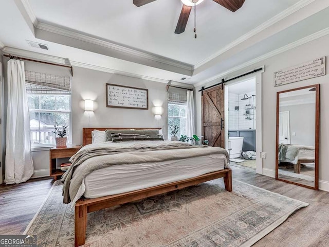 351 Danburg Ct, Jasper, GA 30143 - bedroom with a barn door, multiple windows, wood finished floors, ornamental molding, and baseboards
