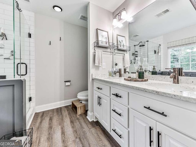 351 Danburg Ct, Jasper, GA 30143 - bathroom featuring double vanity, toilet, wood finished floors, a stall shower, and baseboards