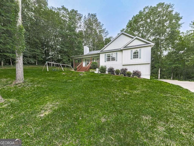 351 Danburg Ct, Jasper, GA 30143 - view of home's exterior featuring a chimney, a yard, view of wooded area, and a playground