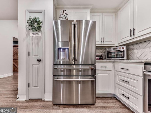 351 Danburg Ct, Jasper, GA 30143 - kitchen with stainless steel refrigerator with ice dispenser, white cabinetry, light wood finished floors, decorative backsplash, and baseboards