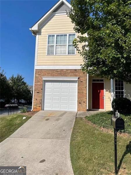 6634 Splashwater Dr, Flowery Branch, GA 30542 - view of front of property featuring brick siding, an attached garage, concrete driveway, and a front yard