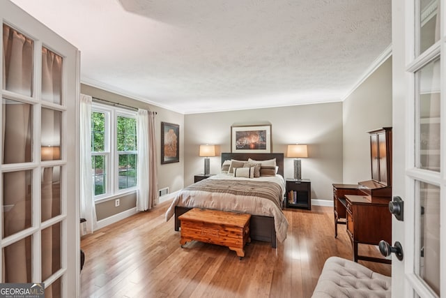 10875 Shagbark Trl, Roswell, GA 30075 - bedroom featuring ornamental molding, hardwood / wood-style flooring, and a textured ceiling