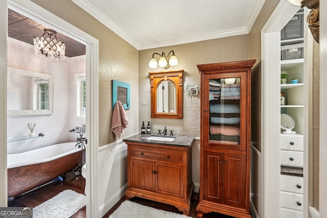 10875 Shagbark Trl, Roswell, GA 30075 - full bathroom featuring crown molding, a freestanding tub, vanity, wood finished floors, and a chandelier