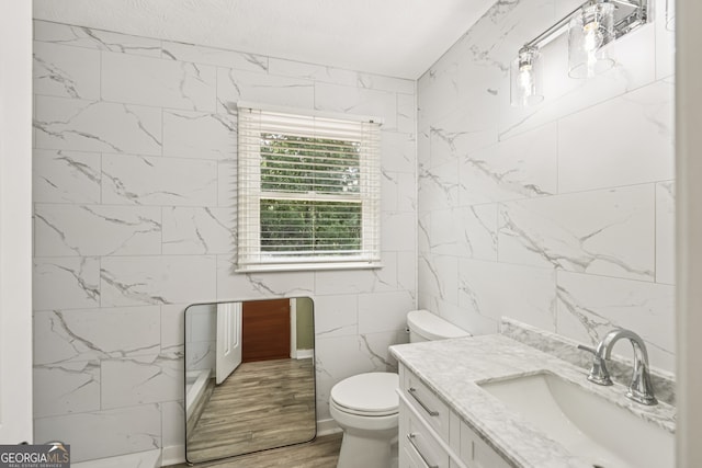 10875 Shagbark Trl, Roswell, GA 30075 - bathroom featuring tile walls, vanity, and wood finished floors