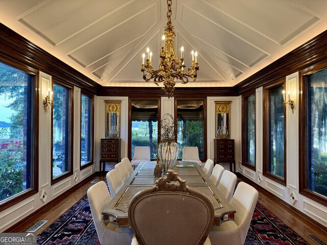 124 N Valhalla Ln, Cordele, GA 31015 - dining area with a chandelier, ornamental molding, plenty of natural light, wood finished floors, and vaulted ceiling