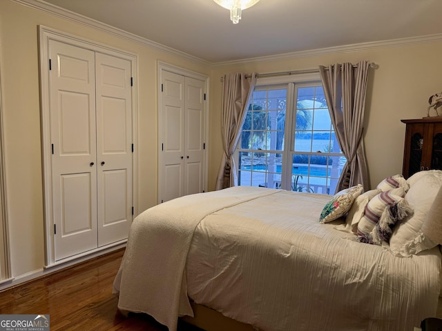 124 N Valhalla Ln, Cordele, GA 31015 - bedroom with dark wood finished floors, ornamental molding, and two closets