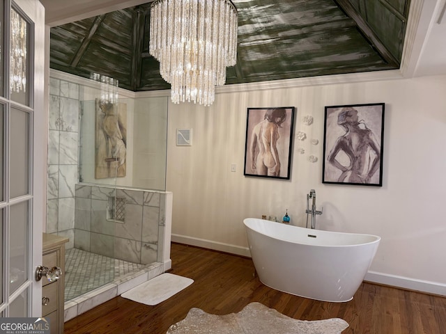 124 N Valhalla Ln, Cordele, GA 31015 - full bath with baseboards, a chandelier, tiled shower, wood finished floors, and a freestanding tub