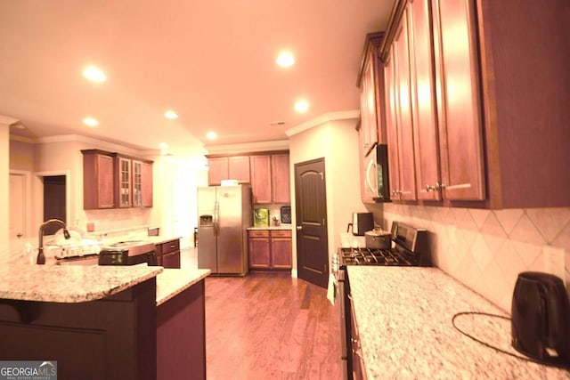 560 Tuscany Walk Ln, Lawrenceville, GA 30043 - kitchen with appliances with stainless steel finishes, crown molding, light stone countertops, recessed lighting, and backsplash