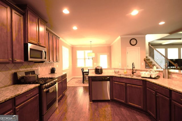 560 Tuscany Walk Ln, Lawrenceville, GA 30043 - kitchen featuring stainless steel appliances, ornamental molding, tasteful backsplash, light stone counters, and dark wood finished floors