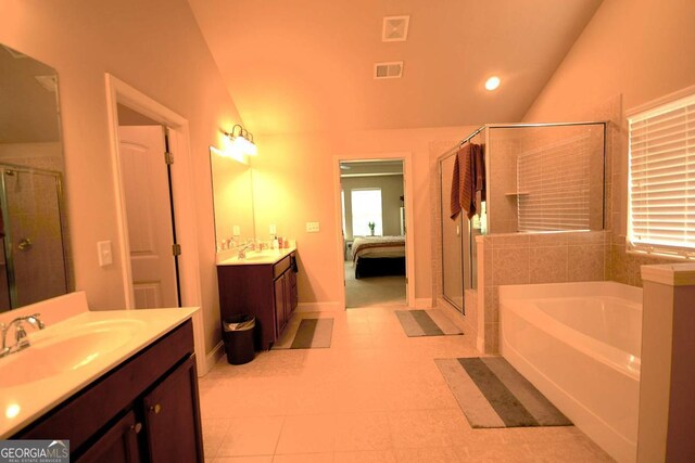 560 Tuscany Walk Ln, Lawrenceville, GA 30043 - full bathroom with vaulted ceiling, a garden tub, a stall shower, two vanities, and recessed lighting