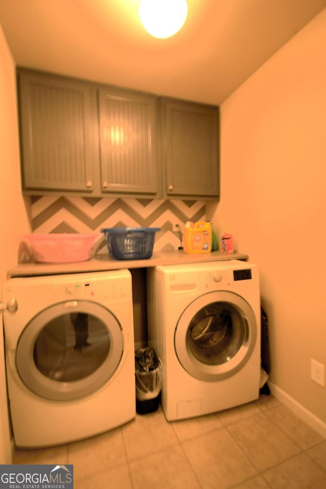 560 Tuscany Walk Ln, Lawrenceville, GA 30043 - laundry room with cabinet space, washing machine and clothes dryer, and light tile patterned flooring