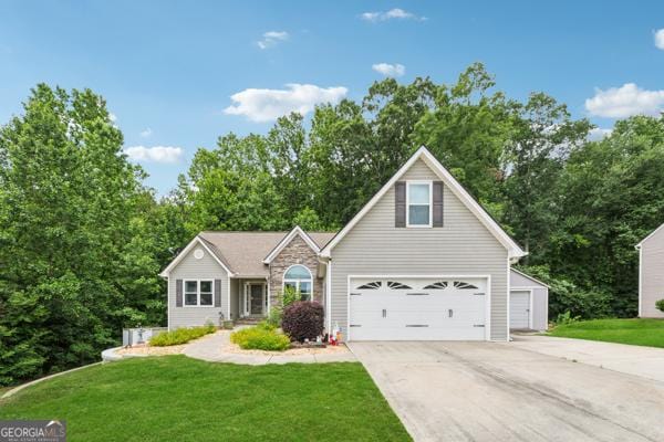 5102 Yellow Stone Dr, Flowery Branch, GA 30542 - traditional-style home with driveway, a front lawn, and stone siding