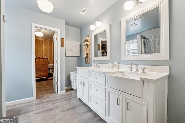 5102 Yellow Stone Dr, Flowery Branch, GA 30542 - bathroom with double vanity, wood finished floors, and baseboards