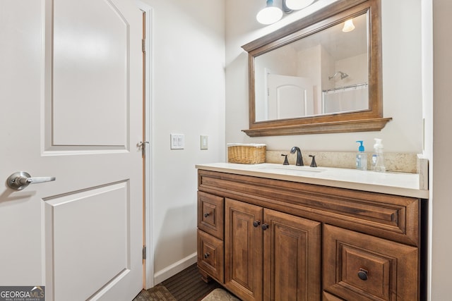 5102 Yellow Stone Dr, Flowery Branch, GA 30542 - bathroom featuring vanity, baseboards, and a shower