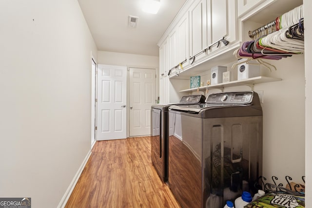 5102 Yellow Stone Dr, Flowery Branch, GA 30542 - washroom featuring cabinet space, separate washer and dryer, light wood finished floors, and baseboards