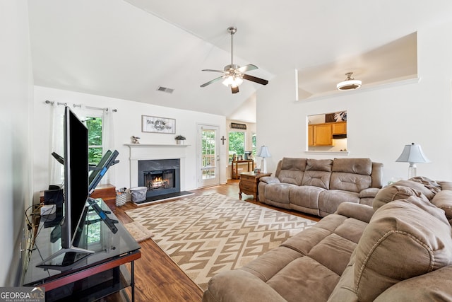 5102 Yellow Stone Dr, Flowery Branch, GA 30542 - living room featuring wood finished floors, a warm lit fireplace, healthy amount of natural light, ceiling fan, and high vaulted ceiling