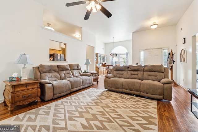 5102 Yellow Stone Dr, Flowery Branch, GA 30542 - living area with wood finished floors, ceiling fan, a high ceiling, and a chandelier