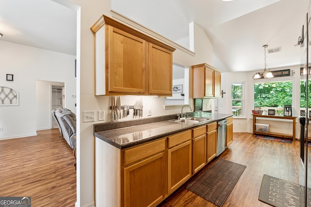 5102 Yellow Stone Dr, Flowery Branch, GA 30542 - kitchen featuring a sink, light wood-style floors, dark countertops, lofted ceiling, and stainless steel dishwasher